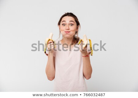 Сток-фото: Portrait Of A Happy Satisfied Girl Eating Bananas