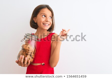Foto stock: A Girl Holding A Jar Of Biscuits