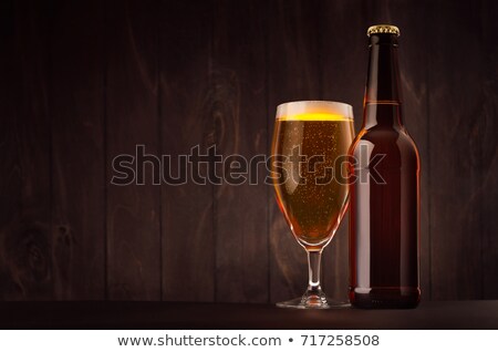 ストックフォト: Brown Beer Bottle And Glass Tulip With Golden Lager On Dark Wood Board Copy Space Mock Up