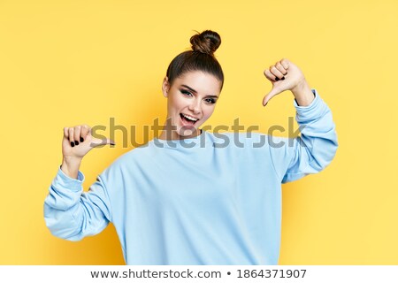 Stockfoto: Smiling Emotional Young Women Friends Posing Isolated Over Yellow Background Pointing