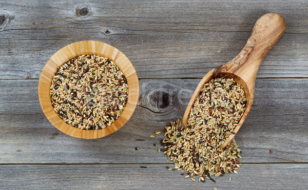 Whole grain rice in wooden kitchenware on rustic wood  Stock photo © tab62