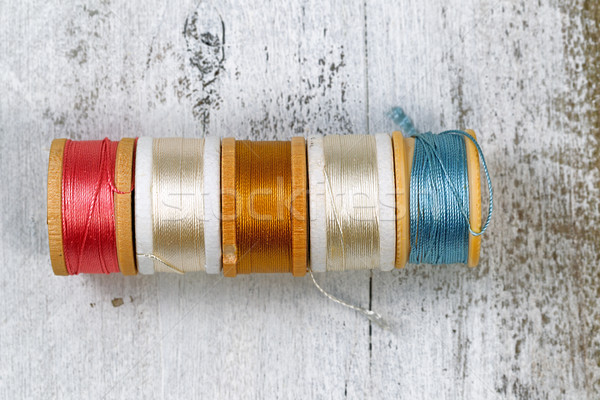 Stock photo: Many colors of thread within their spools 