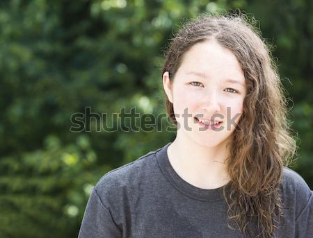 Young Girl Smiling while Looking Forward  Stock photo © tab62