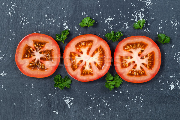 Freshly sliced tomato on black slate stone background  Stock photo © tab62