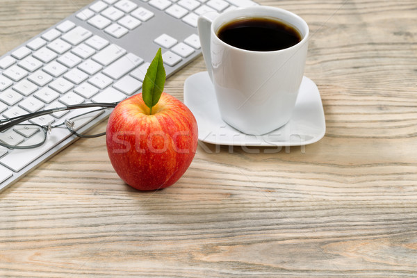 Close up of a ripe red apple for office snack on wooden desktop  Stock photo © tab62