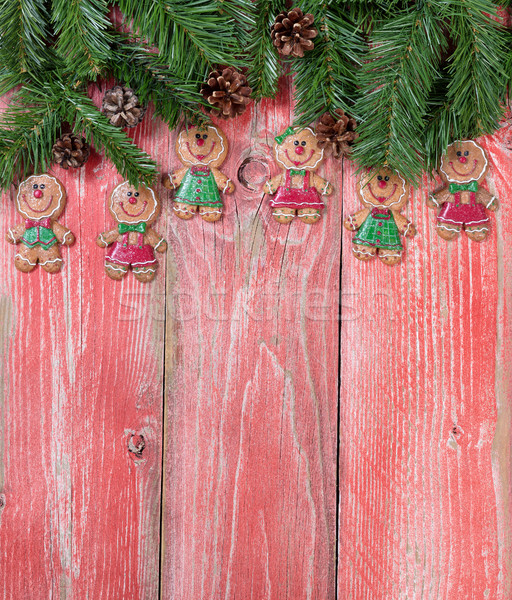 Gingerbread cookies and evergreen branches on rustic red wooden  Stock photo © tab62