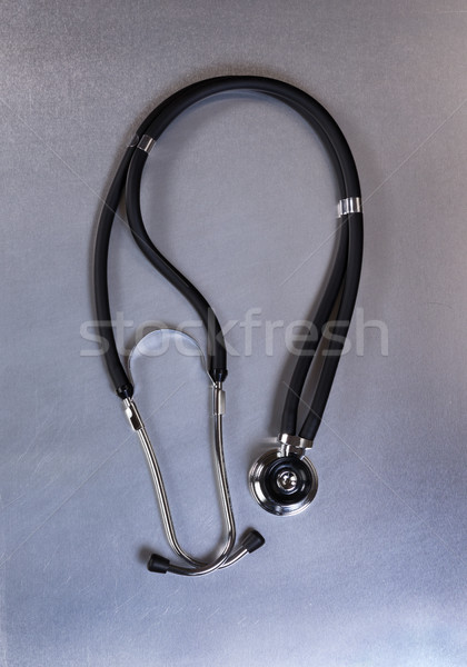 Medical stethoscope on stainless steel table in vertical layout  Stock photo © tab62