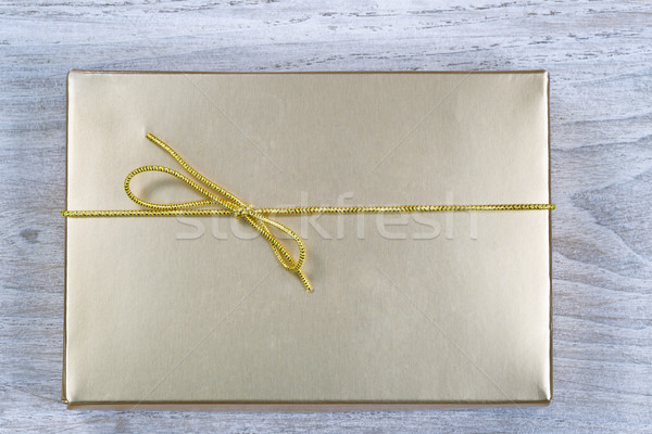 Stock photo: Golden Wrapped Gift Box for the holidays 