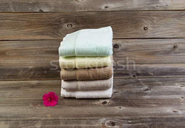 Clean Towels and single pink flower on Weathered Wood Stock photo © tab62