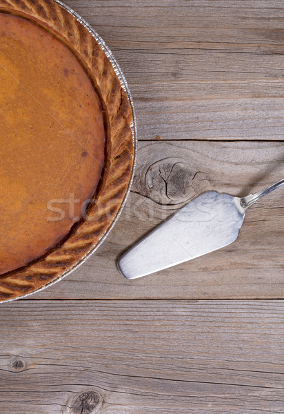 Freshly baked pumpkin pie with spatula on stressed wooden table  Stock photo © tab62