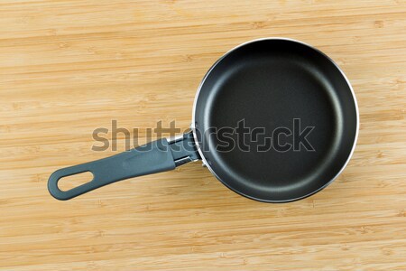 New Frying Pan on Natural Bamboo Wood  Stock photo © tab62
