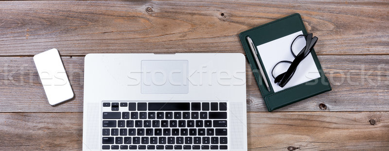 Top view of working desktop with mobile devise and traditional p Stock photo © tab62