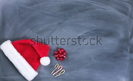 Erased black chalkboard with Santa cap in lower left corner  Stock photo © tab62