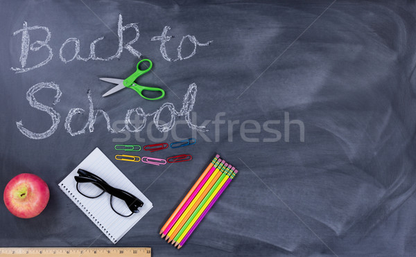 Back to school text on erased chalkboard with student supplies   Stock photo © tab62