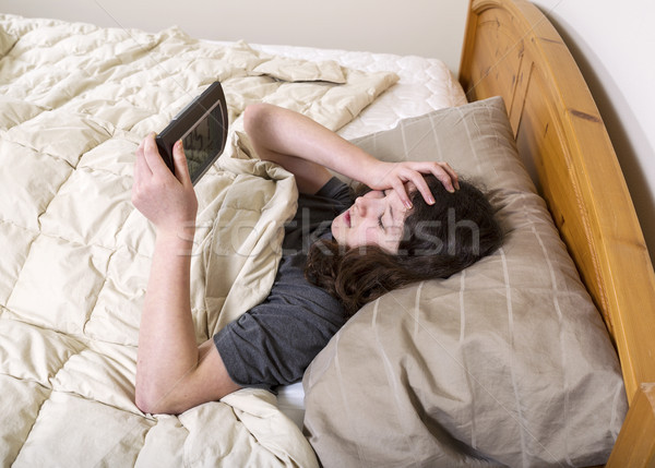 Young girl frustrated by wakeup of alarm clock  Stock photo © tab62