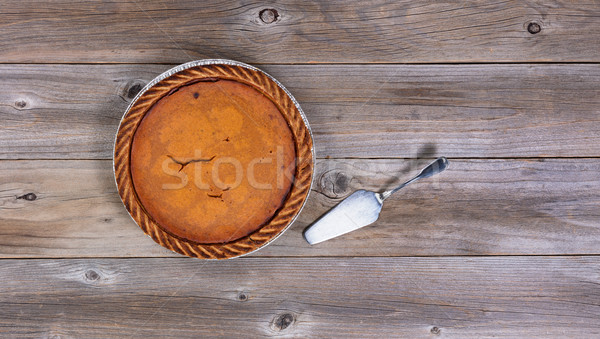 Freshly baked pumpkin pie with spatula on rustic wooden table  Stock photo © tab62