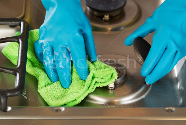 Gloved hands removing soap from stove top range with microfiber  Stock photo © tab62