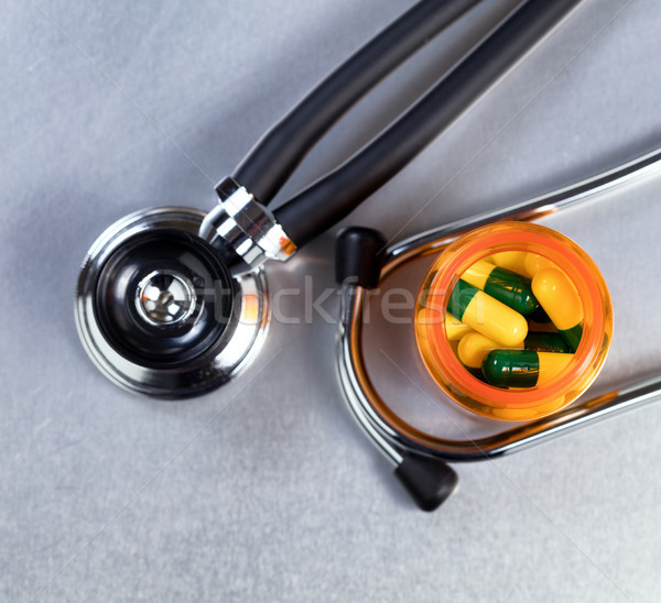 Medicine bottle filled with capsules on stainless steel table wi Stock photo © tab62