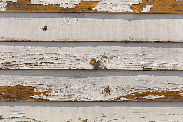 Old and fading paint peeling off of wood sliding Stock photo © tab62