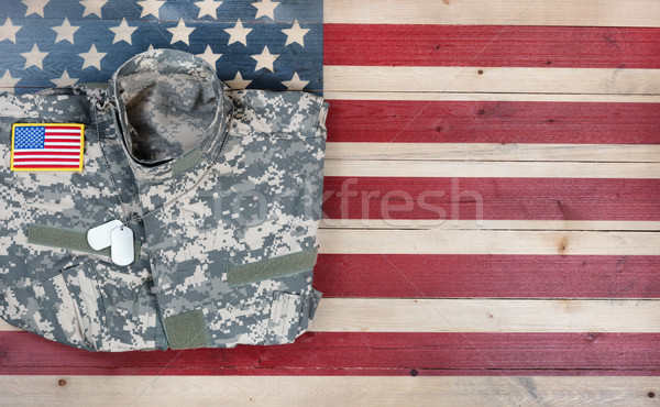 Overhead view of USA military uniform on rustic wooden flag Stock photo © tab62