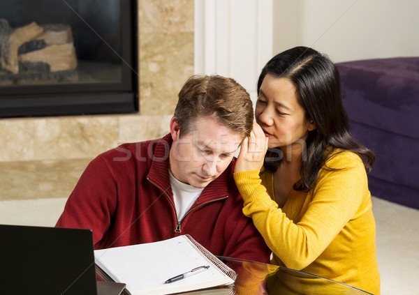 Stock photo: Mature woman whispering into Coworker ear 