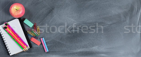 Back to school concept with erased chalkboard and basic supplies Stock photo © tab62