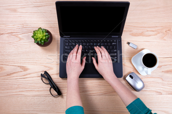 Stock photo: Office desktop setup with female hands working on laptop keyboar