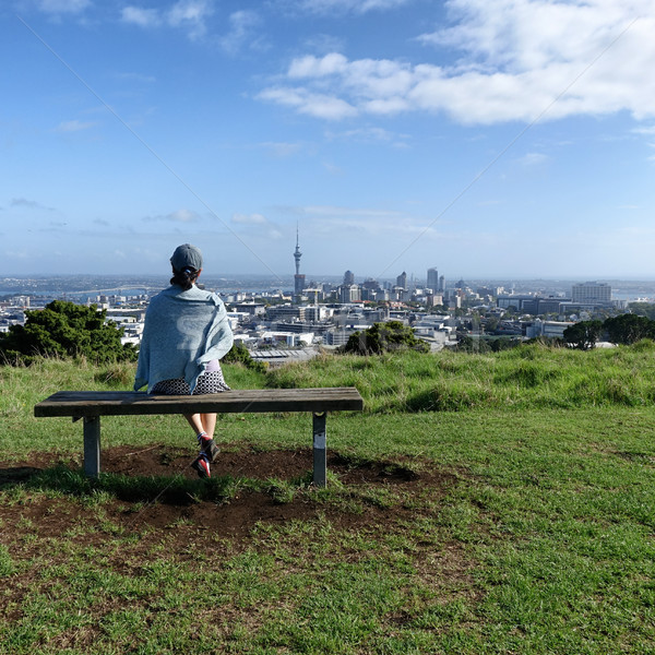 Woman sitting on bench will looking at skyline of Auckland  Stock photo © tab62