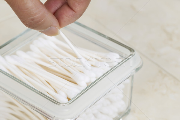 Picking out single cotton swab from container Stock photo © tab62