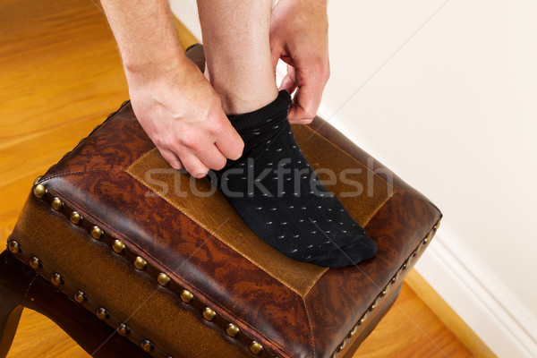 Putting on Dress Sock using Footstool in home  Stock photo © tab62