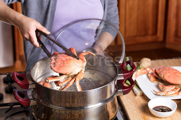 Hand removing cooked crab from steam pot  Stock photo © tab62