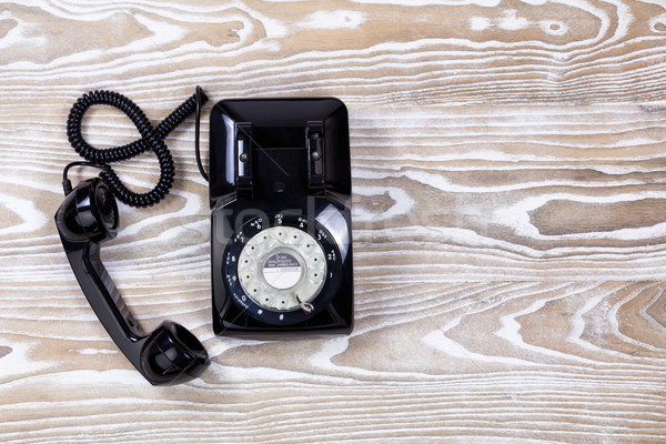 Retro telephone on faded wooden surface Stock photo © tab62