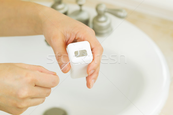 Preparing to Floss in Bathroom Stock photo © tab62