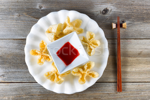 Fried wanton shells and sweet dipping sauce in white bowl on rus Stock photo © tab62