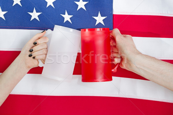 Hands holding drinking mugs with USA flag in background  Stock photo © tab62