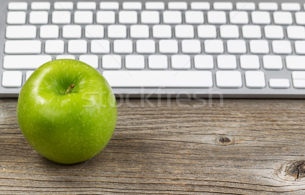 Healthy green apple with keyboard on rustic wooden desktop Stock photo © tab62