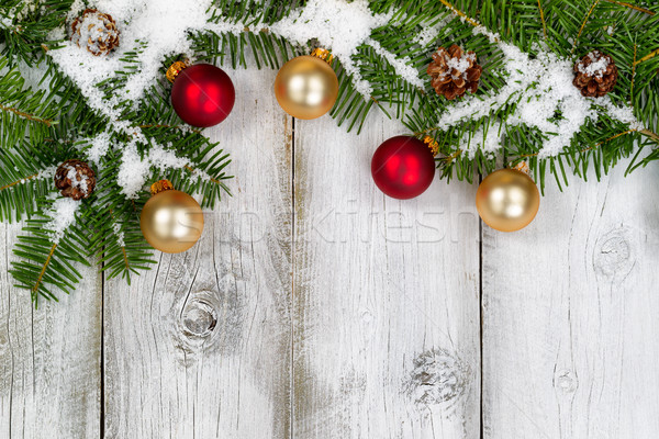 Stock photo: Snow covered fir branches and ornaments on rustic white wooden b