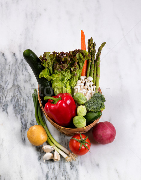 Basket of fresh whole vegetables displayed on natural marble sto Stock photo © tab62