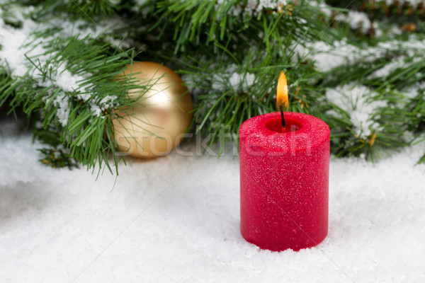 Burning candle with Christmas objects covered with fresh snow Stock photo © tab62