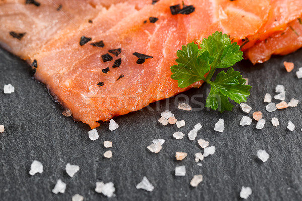 Smoked wild salmon slices with seasoning herbs on natural black  Stock photo © tab62