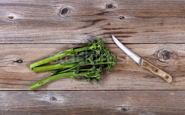 Fresh Chinese broccoli and paring knife on rustic wood  Stock photo © tab62