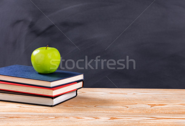 Back to school books and green apple in front of erased black ch Stock photo © tab62
