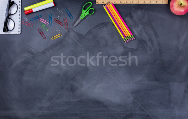 Student school supplies on erased chalkboard  Stock photo © tab62