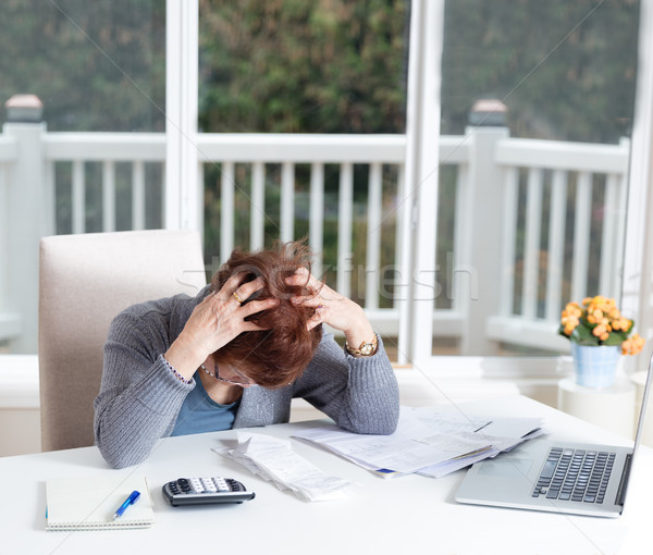 Senior woman showing depression while working on her financial m Stock photo © tab62