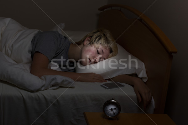 Teen girl has cell phone nearby even in her sleep Stock photo © tab62