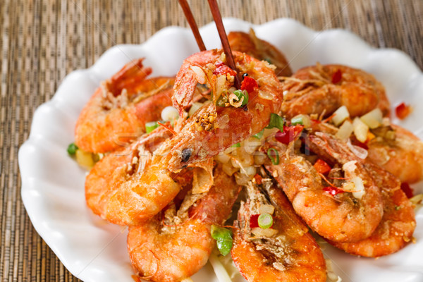 Fried bread coated shrimp and garnishes on white serving plate r Stock photo © tab62