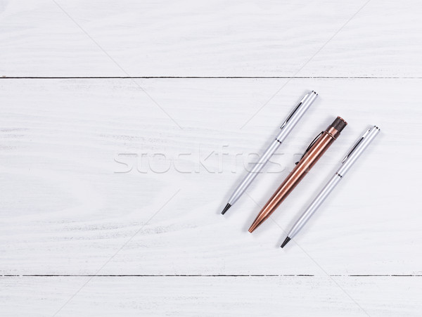 Metal pens on white wood background  Stock photo © tab62