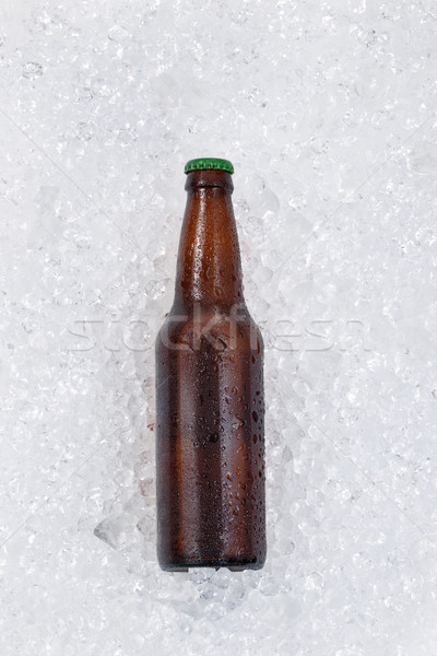 Single bottle of beer cooling down on pile of ice  Stock photo © tab62