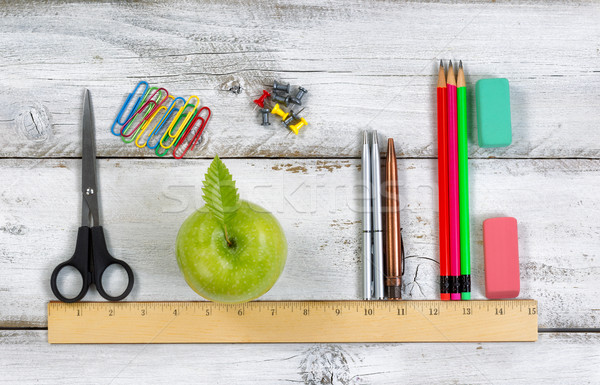 School supplies in line with ruler on white desktop  Stock photo © tab62