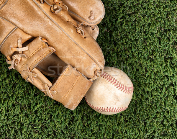 Close up overhead view of old leather baseball and mitt on grass Stock photo © tab62